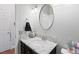 Bathroom features a granite countertop vanity with an oval mirror above the sink at 8121 Eagle Clan Ct, Las Vegas, NV 89131