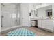 Bright bathroom with marble tile, a glass-enclosed shower, and a dual sink vanity at 8121 Eagle Clan Ct, Las Vegas, NV 89131