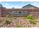Suncrest Trail community sign with a brick wall, rock ground cover, and manicured plants at 8121 Eagle Clan Ct, Las Vegas, NV 89131