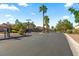 Gated community entrance with palm trees, security cameras, and well-maintained landscaping at 8121 Eagle Clan Ct, Las Vegas, NV 89131
