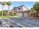 Stately home with a three-car garage, well-manicured landscaping, and a spacious driveway at 8121 Eagle Clan Ct, Las Vegas, NV 89131