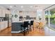 Modern kitchen with stainless steel appliances, island seating, and adjacent dining area at 8121 Eagle Clan Ct, Las Vegas, NV 89131