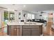 Kitchen island features a stainless steel dishwasher and sink with granite countertops at 8121 Eagle Clan Ct, Las Vegas, NV 89131