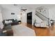 Open-concept living room with a cozy seating area and staircase access at 8121 Eagle Clan Ct, Las Vegas, NV 89131