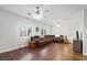 Open living room with hardwood floors, a ceiling fan, and large windows at 8121 Eagle Clan Ct, Las Vegas, NV 89131