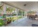 Large, covered patio with dining table and view of a lush backyard with a pool at 8121 Eagle Clan Ct, Las Vegas, NV 89131