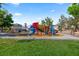 Community playground featuring colorful slides, climbing structures, and benches with views at 8121 Eagle Clan Ct, Las Vegas, NV 89131