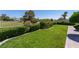Lush backyard with green lawn, manicured hedges, and walkway at 8196 Horseshoe Bend Ln, Las Vegas, NV 89113