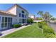 Spacious backyard featuring a manicured lawn, lush shrubbery, and mature trees at 8196 Horseshoe Bend Ln, Las Vegas, NV 89113
