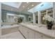 Bright bathroom with double sink vanity, soaking tub, and marble countertops at 8196 Horseshoe Bend Ln, Las Vegas, NV 89113