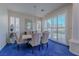 Elegant dining room with stylish chairs, a modern chandelier, blue carpet and plantation shutters at 8196 Horseshoe Bend Ln, Las Vegas, NV 89113