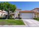 Charming two-story home with red tile roof, manicured lawn, mature tree and gated courtyard at 8196 Horseshoe Bend Ln, Las Vegas, NV 89113