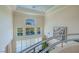 Bright foyer featuring high ceilings, large windows with lake view, and custom railing at 8196 Horseshoe Bend Ln, Las Vegas, NV 89113