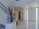 Inviting foyer with curved staircase, white tile floors, decorative lighting, and front door at 8196 Horseshoe Bend Ln, Las Vegas, NV 89113