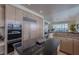 Modern kitchen featuring stainless steel appliances, dark countertops, custom cabinets and breakfast bar at 8196 Horseshoe Bend Ln, Las Vegas, NV 89113