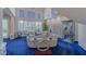 Bright living room with soaring ceilings, large windows, and comfortable seating, blue carpet at 8196 Horseshoe Bend Ln, Las Vegas, NV 89113