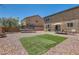 Expansive backyard with gravel, artificial turf, a trampoline, and a covered patio at 8252 Pearl Oasis Ct, Las Vegas, NV 89139