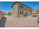 Home exterior highlighting a spacious backyard with gravel, patio set, and barbecue grill at 8252 Pearl Oasis Ct, Las Vegas, NV 89139