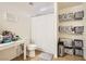 Simple bathroom with a toilet, shower with a curtain, vanity, and organization containers on shelves at 8252 Pearl Oasis Ct, Las Vegas, NV 89139
