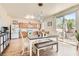 Bright dining area with wood-look floors, modern lighting, and a sliding glass door to the backyard at 8252 Pearl Oasis Ct, Las Vegas, NV 89139