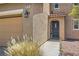 Close up view of a front door and two-car garage on a charming two-story home at 8252 Pearl Oasis Ct, Las Vegas, NV 89139