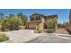 Charming two-story home with a two-car garage, dark shutters, and neutral stucco under a clear blue sky at 8252 Pearl Oasis Ct, Las Vegas, NV 89139