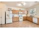 Functional kitchen with light wood cabinets, white appliances, and tile flooring at 8252 Pearl Oasis Ct, Las Vegas, NV 89139
