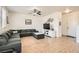 Spacious living room with a large sectional sofa, ceiling fan, and wood-look floors at 8252 Pearl Oasis Ct, Las Vegas, NV 89139