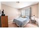 Bedroom featuring a twin bed, mounted TV, and large window at 8700 Isola Dr, Las Vegas, NV 89117