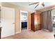 Bedroom featuring an armoire, doorway to bathroom, and sliding glass door to outside patio at 8700 Isola Dr, Las Vegas, NV 89117
