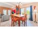 Inviting dining area with a brick fireplace and large windows showcasing natural light at 8700 Isola Dr, Las Vegas, NV 89117