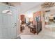 Inviting foyer leading to a cozy living room with a brick fireplace and comfortable seating at 8700 Isola Dr, Las Vegas, NV 89117