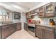 Stylish kitchen featuring gray backsplash, stainless steel appliances and modern cabinetry at 8700 Isola Dr, Las Vegas, NV 89117