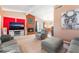 Comfortable living room featuring a brick fireplace and neutral tones throughout at 8700 Isola Dr, Las Vegas, NV 89117