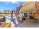 Inviting covered patio with comfortable seating, perfect for outdoor gatherings and relaxation at 8700 Isola Dr, Las Vegas, NV 89117