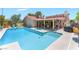 Sparkling in-ground pool and spa with a covered patio perfect for relaxing and entertaining at 8700 Isola Dr, Las Vegas, NV 89117
