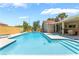Beautiful in-ground pool with steps and baja shelf for sunbathing and enjoying the outdoors at 8700 Isola Dr, Las Vegas, NV 89117