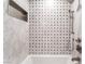 Close up of shower with marble-look tile, a built-in niche, and mounted shower head at 8700 Isola Dr, Las Vegas, NV 89117