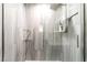 Close up of glass enclosed shower with fixtures and marble-look tile at 8700 Isola Dr, Las Vegas, NV 89117