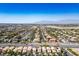 Expansive view of a residential neighborhood with well-manicured lawns and mountain views on the horizon at 8884 Perfect Diamond Ct, Las Vegas, NV 89129