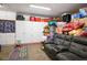 Finished basement with a comfortable couch, hopscotch rug, and ample storage solutions at 8884 Perfect Diamond Ct, Las Vegas, NV 89129