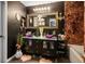 Stylish bathroom featuring a double vanity with purple glass sinks, black cabinets and textured walls at 8884 Perfect Diamond Ct, Las Vegas, NV 89129