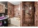 Bathroom featuring a soaking tub and a stall shower with marbled tile at 8884 Perfect Diamond Ct, Las Vegas, NV 89129