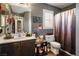 Well-organized bathroom with vanity, toilet, shower curtain, and decor at 8884 Perfect Diamond Ct, Las Vegas, NV 89129