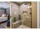 Modern shower with gray tile, rainfall shower head, and a view into the attached bedroom at 8884 Perfect Diamond Ct, Las Vegas, NV 89129