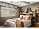 Cozy bedroom featuring a decorative headboard, a window, and a ceiling fan at 8884 Perfect Diamond Ct, Las Vegas, NV 89129
