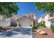 Charming two-story home showcases desert landscaping, a two-car garage, and mature shade trees at 8884 Perfect Diamond Ct, Las Vegas, NV 89129