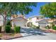 Three homes featuring a red tile roof, desert landscaping, and two-car garage offer comfortable living at 8884 Perfect Diamond Ct, Las Vegas, NV 89129