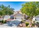 Charming two-story home features a well-maintained yard, a two-car garage, and desert landscaping at 8884 Perfect Diamond Ct, Las Vegas, NV 89129