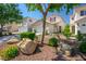 Beautiful two-story home boasts desert landscaping, mature trees, and a well-kept lawn at 8884 Perfect Diamond Ct, Las Vegas, NV 89129